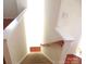 Carpeted stairway with white risers, wooden handrail and access to the lower level at 5963 Pale Moss Ln, Charlotte, NC 28269