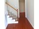 Classic stairway with carpeted steps and a wooden railing, providing access to the upper level of the home at 5963 Pale Moss Ln, Charlotte, NC 28269