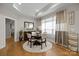 Elegant dining room with a round table, stylish chairs, and ample natural light at 6015 Pleasant Run Dr, Matthews, NC 28104