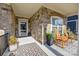 Charming front porch with brick accents, rocking chairs, and a welcoming entrance at 6015 Pleasant Run Dr, Matthews, NC 28104