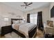 Comfortable main bedroom features a ceiling fan, dark furniture, and wood floors at 6015 Pleasant Run Dr, Matthews, NC 28104