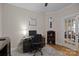 Cozy office with hardwood floors, a desk, and a glass-paneled door at 6015 Pleasant Run Dr, Matthews, NC 28104