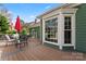 Cozy back deck featuring outdoor seating, with views of a landscaped yard at 613 Trailing Rock Dr, Charlotte, NC 28214