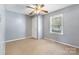 This bedroom features a ceiling fan, a window, and a closet at 629 Johns Ln, Gastonia, NC 28052