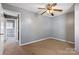 This bedroom includes a ceiling fan and an adjoining bathroom at 629 Johns Ln, Gastonia, NC 28052