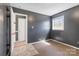 Bedroom featuring neutral carpet and a window overlooking the backyard at 629 Johns Ln, Gastonia, NC 28052