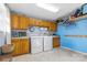 Functional laundry room with washer, dryer, ample storage, and tile floors at 6325 Foster Rd, Woodleaf, NC 27054