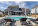 Inviting pool area with lounge chairs, umbrellas, and a covered patio, perfect for outdoor entertaining at 7133 Sumters Camp Trl, Fort Mill, SC 29707