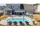 Gorgeous outdoor oasis with a private pool, lounge chairs, and covered dining area at 7133 Sumters Camp Trl, Fort Mill, SC 29707
