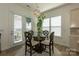 Bright breakfast nook featuring glass table, decorative chandelier, lots of light and access to balcony at 7133 Sumters Camp Trl, Fort Mill, SC 29707