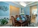 Dining room featuring a modern chandelier, decorative wall panels, seating for six, and light blue walls at 7133 Sumters Camp Trl, Fort Mill, SC 29707