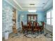 Bright dining room with blue walls, a chandelier, white trees, and a wooden table with seating for six at 7133 Sumters Camp Trl, Fort Mill, SC 29707