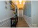 Bright entryway featuring beautiful wall accents, wood floors, and a decorative foyer table with fresh flowers at 7133 Sumters Camp Trl, Fort Mill, SC 29707