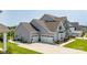 Side view of the home with a spacious three-car garage and well-maintained landscaping at 7133 Sumters Camp Trl, Fort Mill, SC 29707