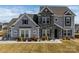 Charming two-story home with a stone facade and well-manicured lawn at 7133 Sumters Camp Trl, Fort Mill, SC 29707