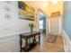 Welcoming foyer featuring a decorative console table, artwork, high ceilings, and a front door with sidelights at 7133 Sumters Camp Trl, Fort Mill, SC 29707