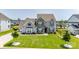 Beautifully landscaped home with a lush green lawn, a long driveway, and mature trees at 7133 Sumters Camp Trl, Fort Mill, SC 29707