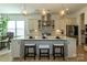 Island kitchen featuring modern pendant lighting, stainless steel appliances, and a mosaic tile backsplash at 7133 Sumters Camp Trl, Fort Mill, SC 29707