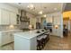 Open concept kitchen with an island, pendant lights, stainless steel appliances, and tile backsplash at 7133 Sumters Camp Trl, Fort Mill, SC 29707