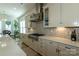 Beautiful kitchen features stainless steel range hood and appliances, light countertops and mosaic tile backsplash at 7133 Sumters Camp Trl, Fort Mill, SC 29707