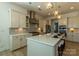 A beautifully designed kitchen with large island and stainless steel appliances, accented with stylish pendant lighting at 7133 Sumters Camp Trl, Fort Mill, SC 29707