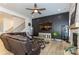 Comfortable living room with contemporary decorative wall, modern ceiling fan, fireplace and lots of seating at 7133 Sumters Camp Trl, Fort Mill, SC 29707