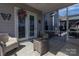 Cozy screened-in patio featuring neutral toned furniture and a view of the home's exterior and pool at 7133 Sumters Camp Trl, Fort Mill, SC 29707