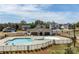 Aerial view of community pool and clubhouse surrounded by well-manicured lawns and neighborhood homes at 7133 Sumters Camp Trl, Fort Mill, SC 29707