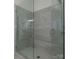 Large glass shower enclosure showcasing neutral tile and a built-in bench at 7133 Sumters Camp Trl, Fort Mill, SC 29707