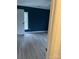 Bedroom features blue accent wall, wood-look floors, and a door leading to an outside view at 730 Jackson Rd, Salisbury, NC 28146