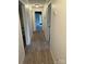 Hallway features wood-look flooring, white walls, and doors to other rooms at 730 Jackson Rd, Salisbury, NC 28146