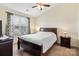 Cozy bedroom featuring a large window, ceiling fan and classic wooden furnishings at 811 Gentlewinds Ct, Fort Mill, SC 29708