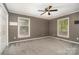 Bright bedroom with carpet offers natural light, ceiling fan, and closet space at 8850 Hills Dell Dr, Concord, NC 28027