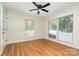 Bright bedroom with natural light, hardwood floors, and a ceiling fan at 8850 Hills Dell Dr, Concord, NC 28027