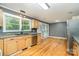 Bright kitchen with stainless steel appliances, grey walls, and hardwood floors at 8850 Hills Dell Dr, Concord, NC 28027