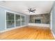 Spacious living room with hardwood floors, stone fireplace, and large windows at 8850 Hills Dell Dr, Concord, NC 28027