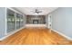 Bright living room with hardwood floors, stone fireplace, and large windows at 8850 Hills Dell Dr, Concord, NC 28027