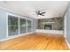 Spacious living room with hardwood floors, stone fireplace, and large windows at 8850 Hills Dell Dr, Concord, NC 28027