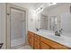 Bathroom featuring double sinks, tile floors, and walk in shower with glass door at 910 Pine Knoll Rd # 13, Fort Mill, SC 29715
