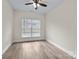 Bright bedroom features a ceiling fan, window, and wood-look flooring at 910 Pine Knoll Rd # 13, Fort Mill, SC 29715