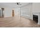 Bright open-concept living room featuring hardwood floors, fireplace, and view of the backyard at 910 Pine Knoll Rd # 13, Fort Mill, SC 29715