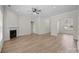 Open-concept living room features hardwood floors, a fireplace, and an arched entryway to dining room at 910 Pine Knoll Rd # 13, Fort Mill, SC 29715