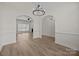 Spacious living room features hardwood floors, arched entryway, and modern chandelier at 910 Pine Knoll Rd # 13, Fort Mill, SC 29715