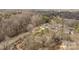Aerial view of a peaceful neighborhood with winding roads, mature trees, and a mix of cozy homes at 910 Pine Knoll Rd # 13, Fort Mill, SC 29715