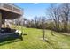 Expansive backyard with a covered patio, perfect for outdoor relaxation with outdoor furniture and tree views at 9433 Wallace Pond Dr, Huntersville, NC 28078