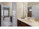 Bright bathroom featuring vanity with sink, neutral tile floors and a view into an adjacent room at 9433 Wallace Pond Dr, Huntersville, NC 28078
