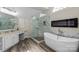 Luxurious bathroom with a freestanding tub, glass shower, vanity, and modern fixtures at 9433 Wallace Pond Dr, Huntersville, NC 28078