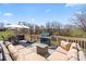 Spacious deck with outdoor dining and lounging furniture, ideal for entertaining with a gas grill and tree views at 9433 Wallace Pond Dr, Huntersville, NC 28078