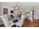 Cozy dining area features hardwood floors, modern lighting, and access to the living room and a built-in workstation at 9433 Wallace Pond Dr, Huntersville, NC 28078