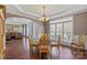 Elegant dining room with hardwood floors, chandelier, and large windows providing ample natural light at 9433 Wallace Pond Dr, Huntersville, NC 28078